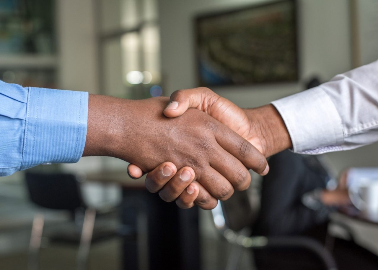 Businessmen shaking hands as a brand partnership is formed