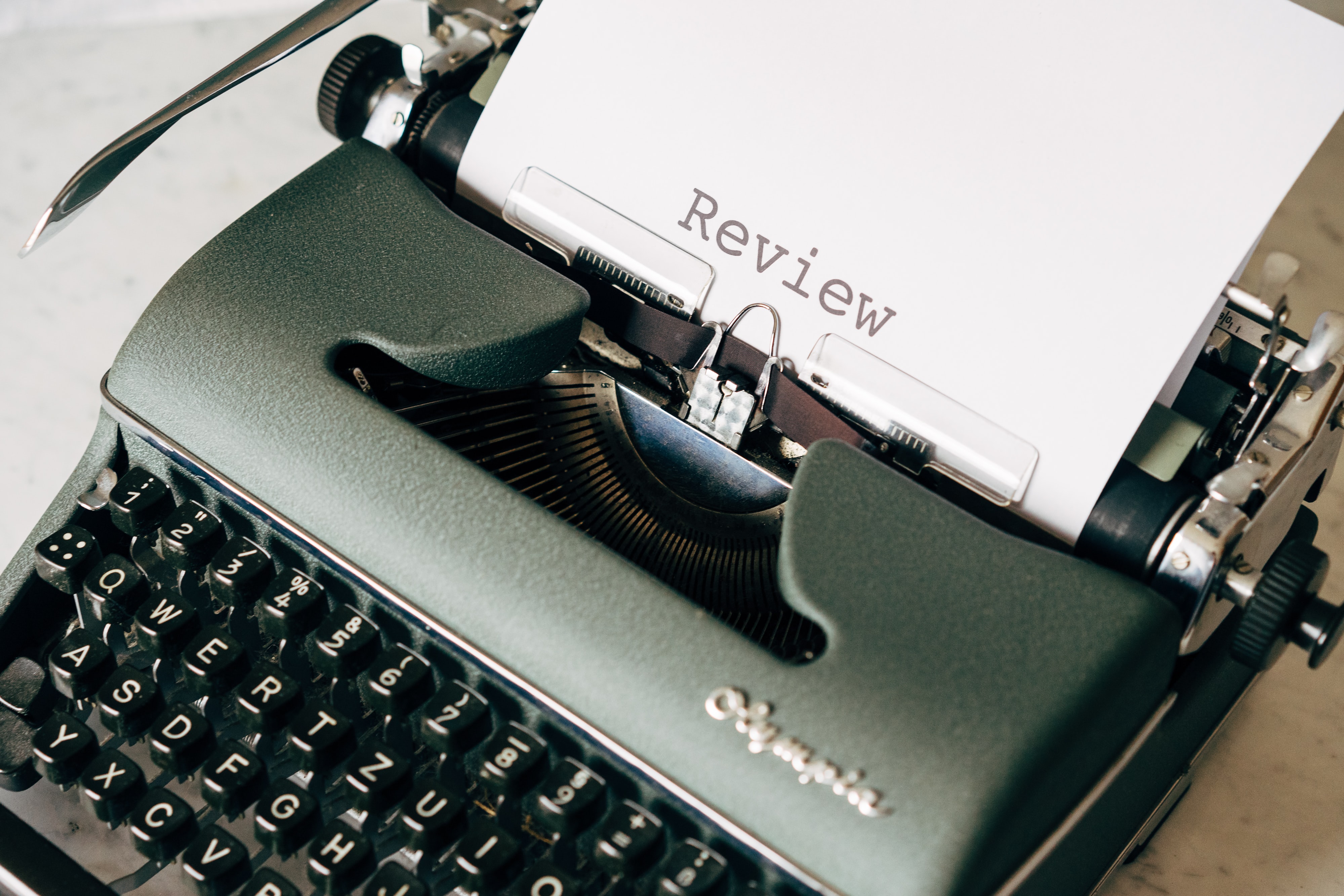 Typewriter writing the word Review to represent finding sales copy mistakes